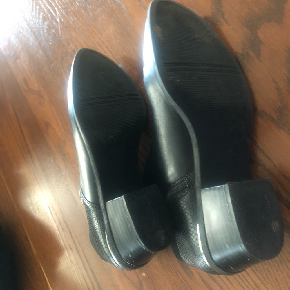 Black ankle boots, some scuffing on heels.